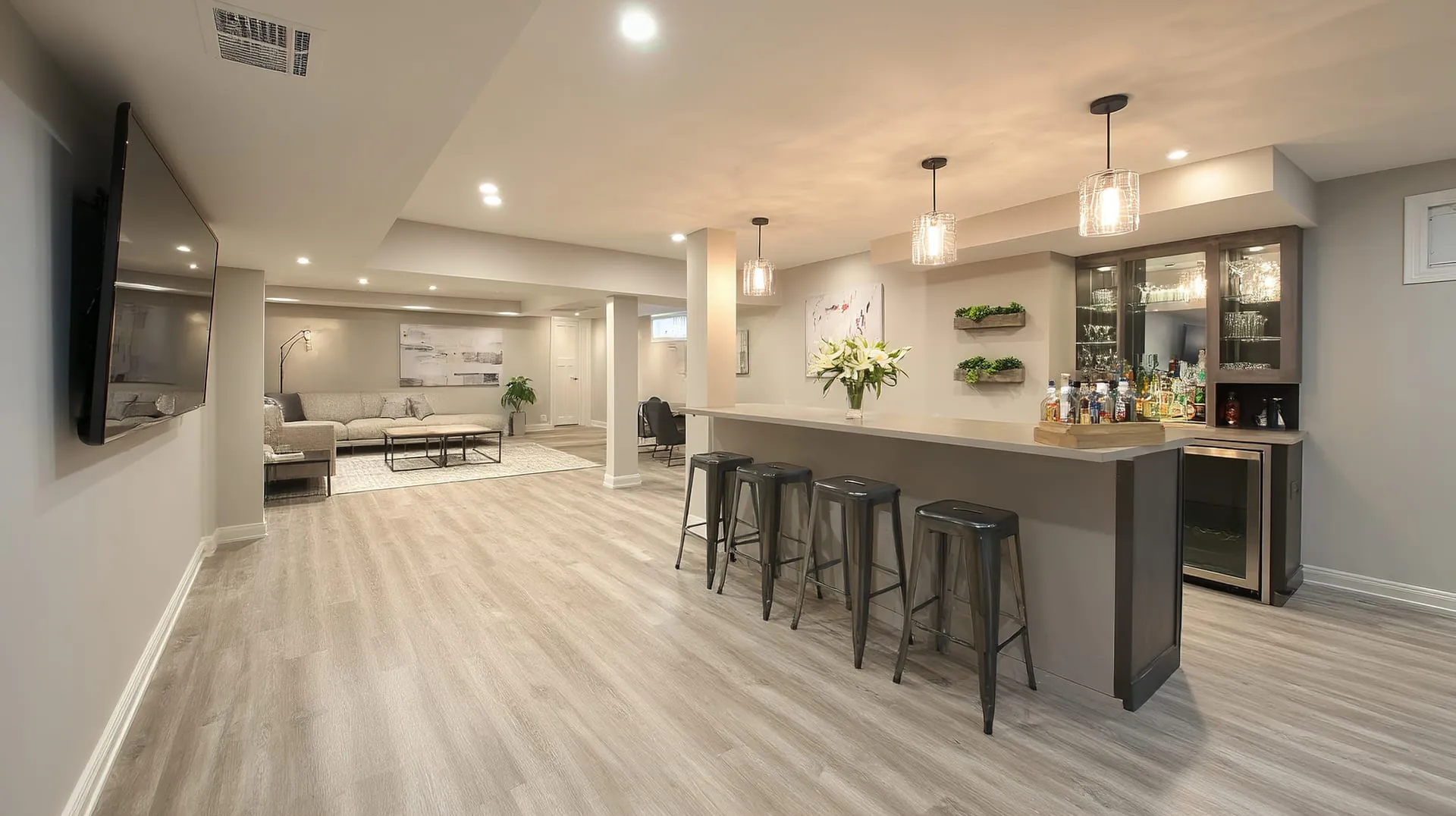 Finished basement with a wet bar by Building America Construction